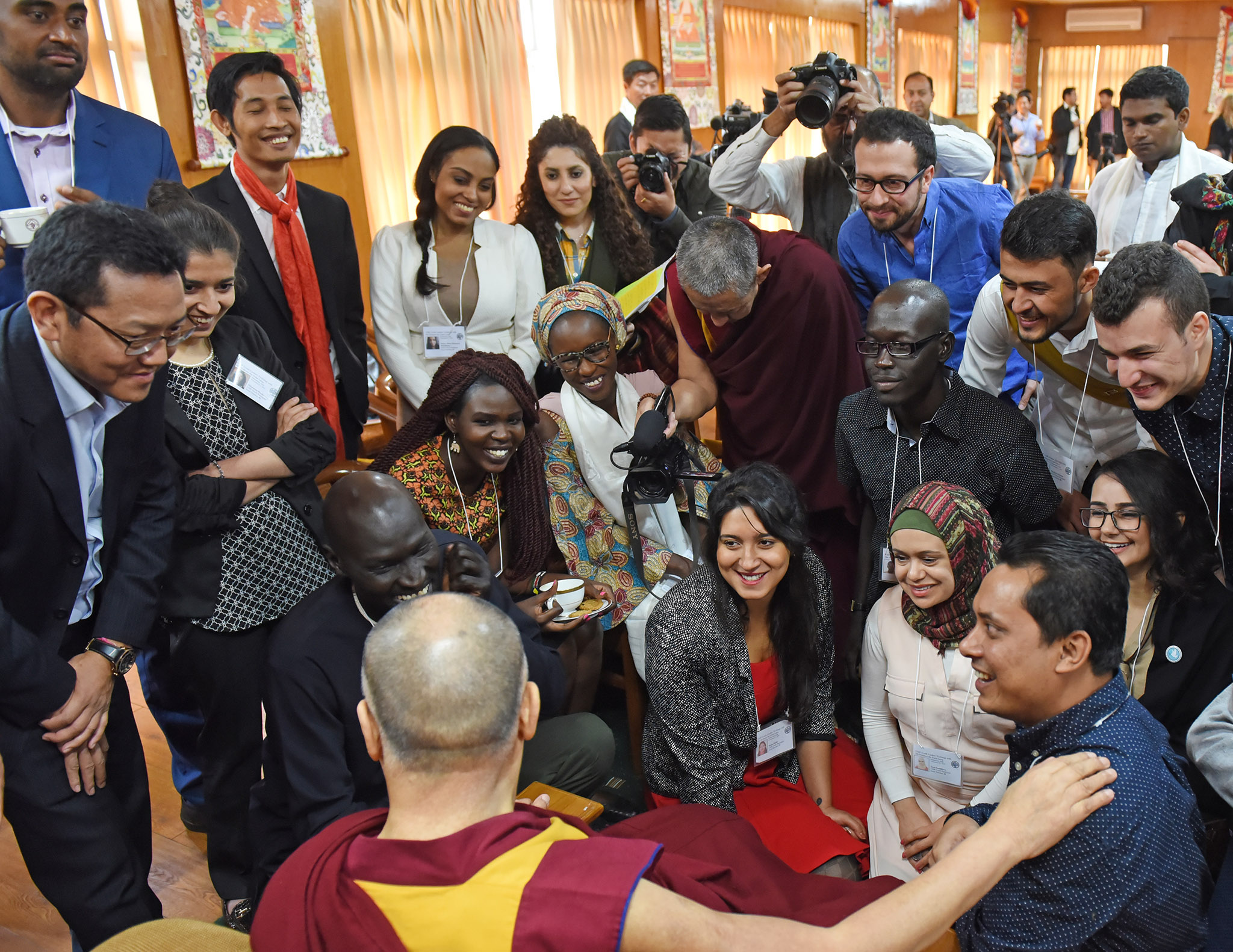 Gatkuoth (center-right in black shirt) says his mentorship by the Dalai Lama and help from USIP have strengthened his work.