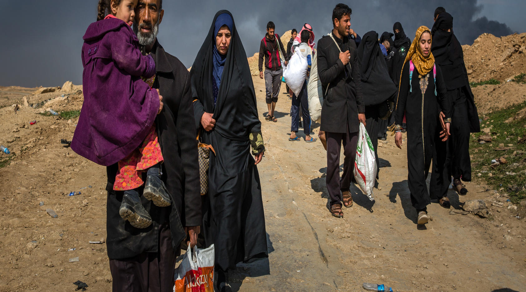 Civilians flee clashes between Iraqi forces and Islamic State fighters in western Mosul, Iraq, March 7, 2017. Car bombs snipers, mortar fire and coalition airstrikes have all taken a heavy toll on civilians during the offensive to oust the Islamic State group from Mosul. 