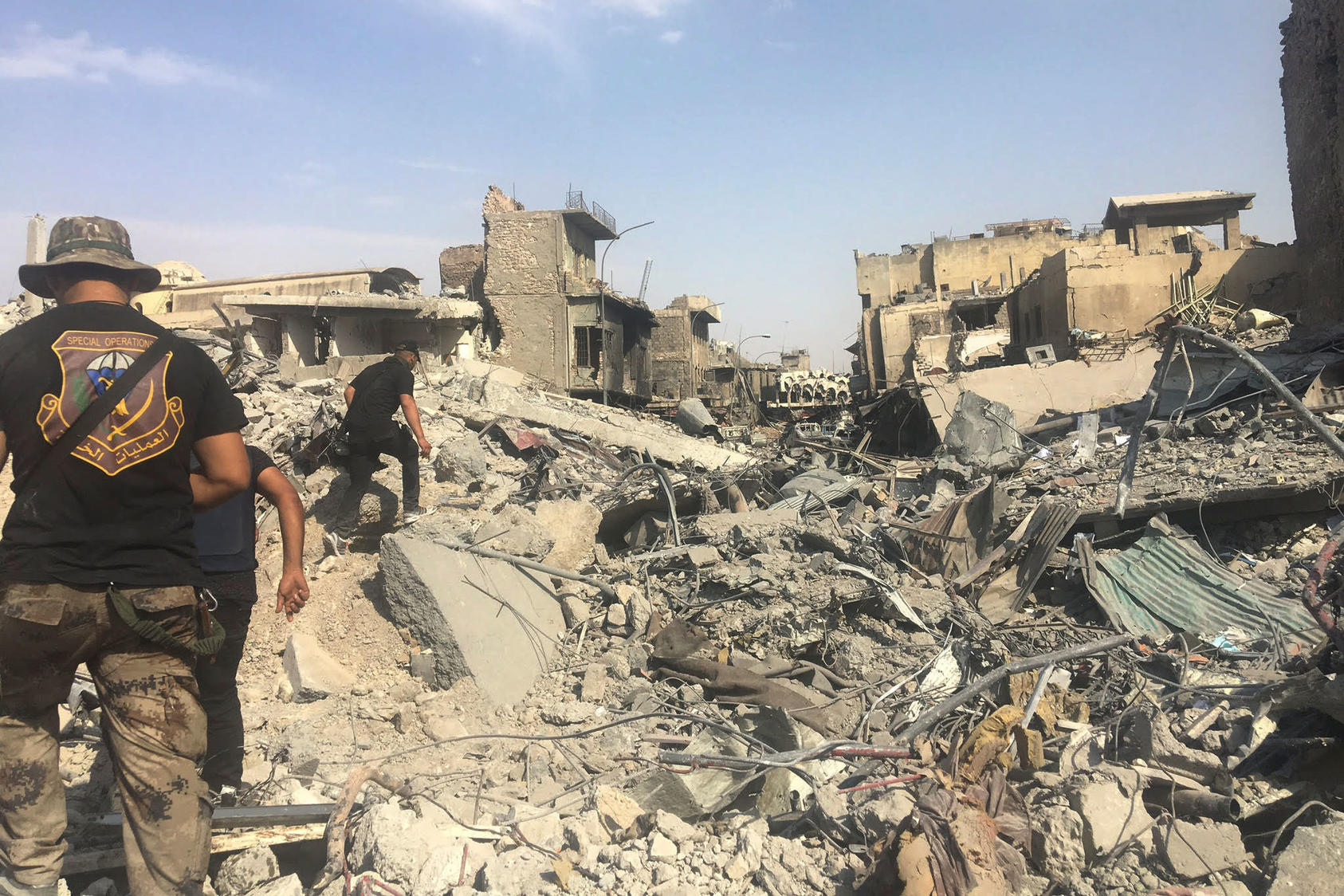 Soldiers pick their way through the ruins of Mosul, Iraq, July 11, 2017. Though Iraq officially declared victory over the Islamic State in Mosul on Sunday, a day later artillery fire could be heard in pockets of the city. 
