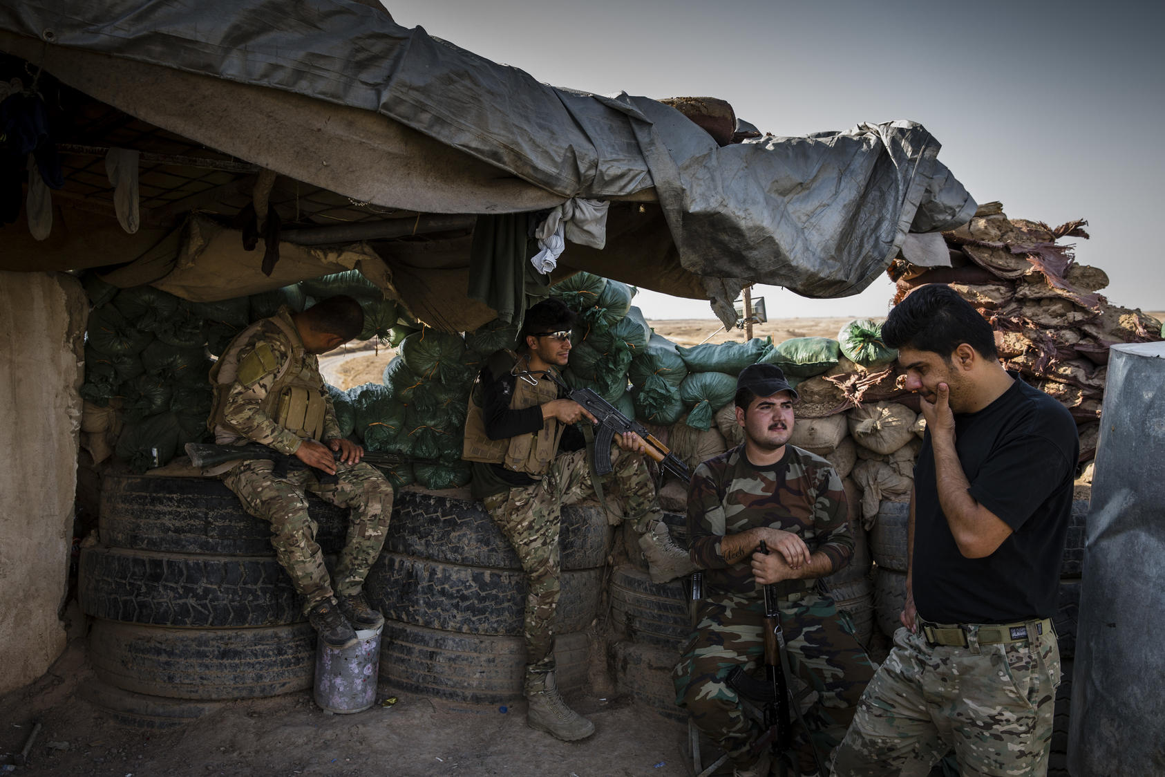 Kurdish peshmerga soldiers at a front-line position along the eastern edge of territory still held by Islamic State militants, near the city of Hawija, Iraq, Aug. 27, 2017.