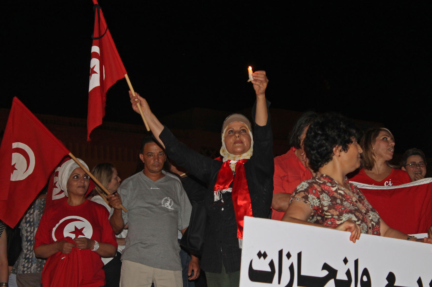 Activists organize a candlelight protest in Tunis