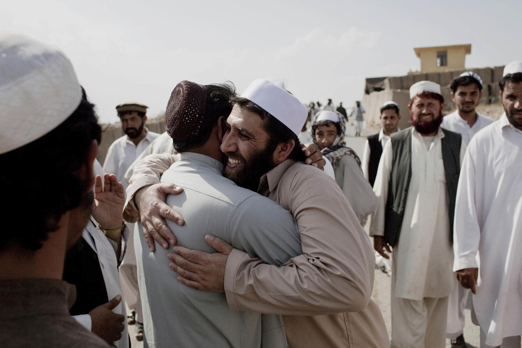 A former detainee is greeted by friends and relatives after his release from a shura at the Operational Coordination Center Provincial in the Khost Province of Afghanistan. (Photo Credit: Adam Ferguson/The New York Times)