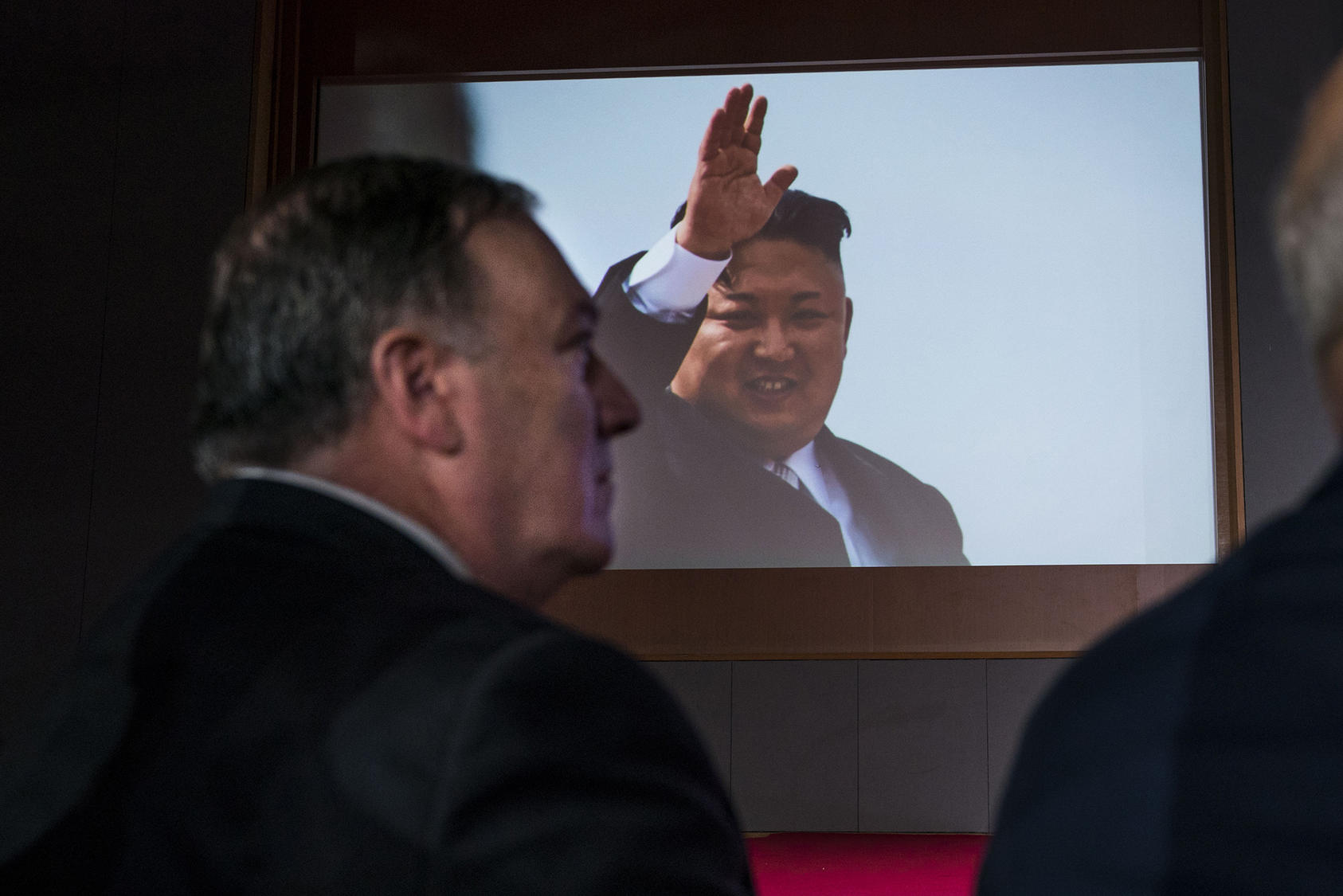 Secretary Pompeo looks on as a video displays Kim Jong Un before President Donald Trump’s news conference on Sentosa Island in Singapore, June 12, 2018. (Doug Mills/The New York Times)