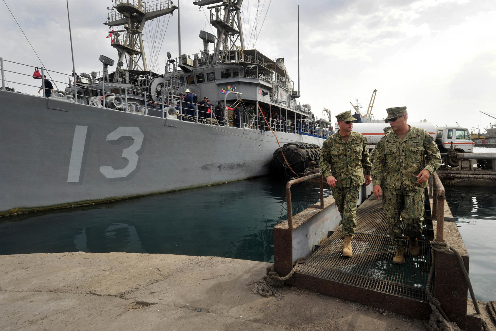 Rear Adm. John Scorby, then commander of Navy Region Europe, Africa, Southwest Asia, left, speaks with Cmdr. Jeffrey Marty, right, during a brief of port operations in the port of Djibouti on May 19, 2015. (Photo: U.S. Navy)