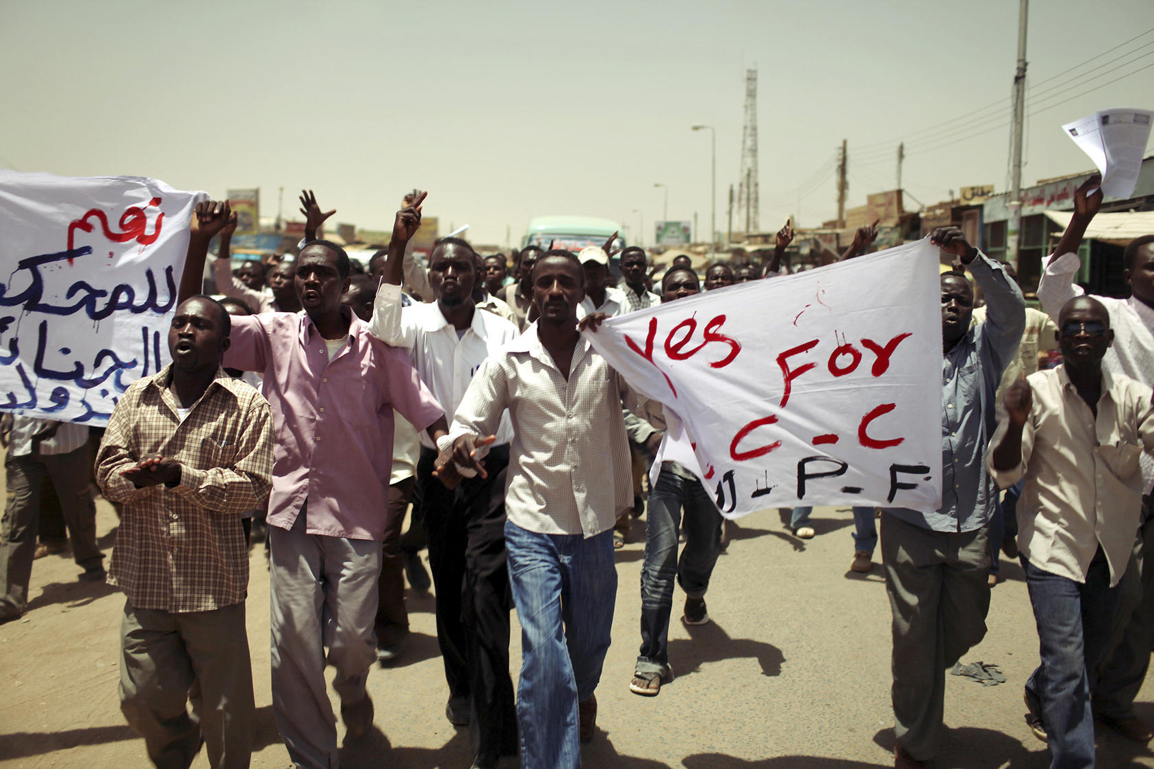 Darfurian men protest against dictator Omar al-Bashir in the streets of Khartoum, Sudan, April 11, 2010. (Jehad Nga/The New York Times).
