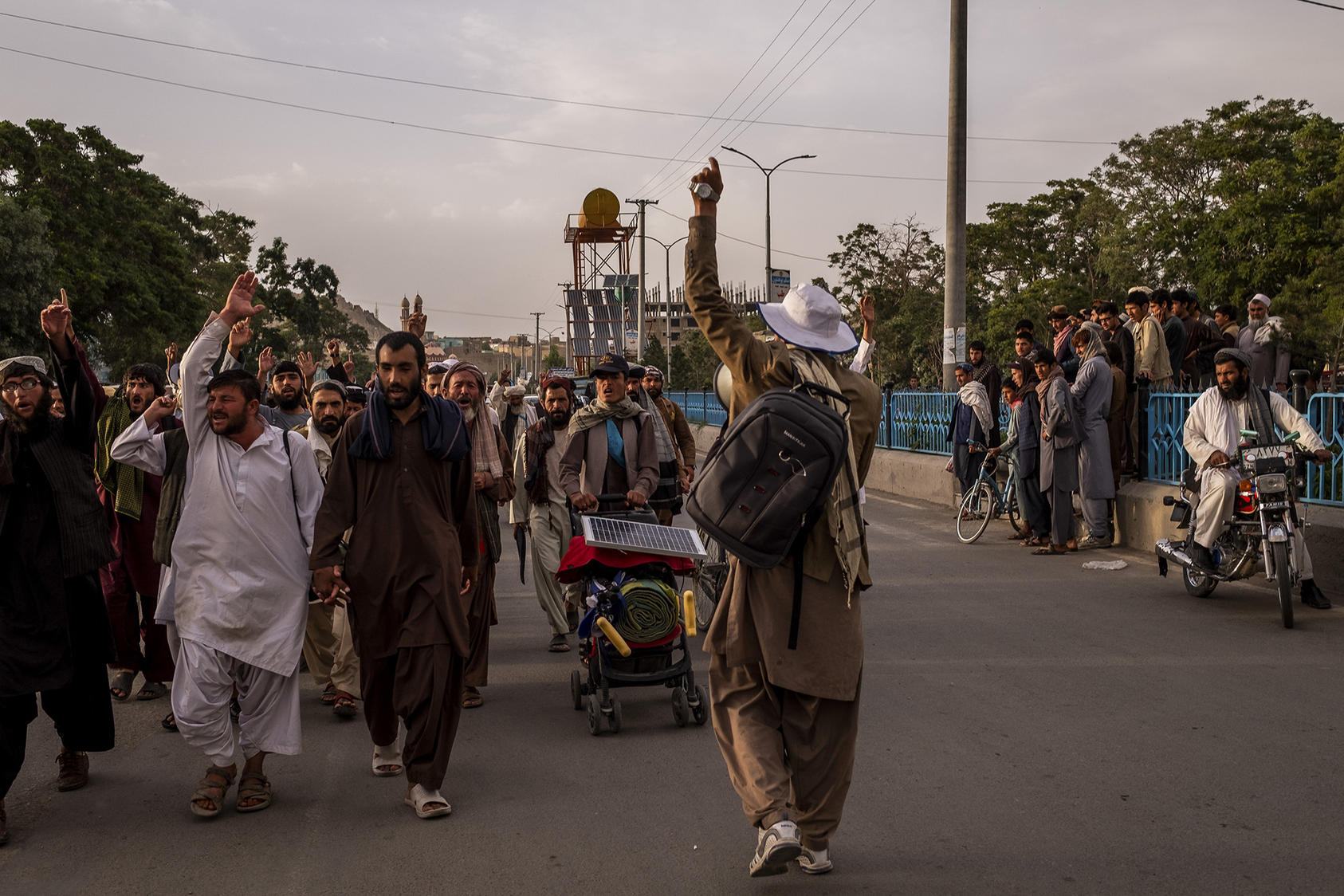 Members of a peace march walk through Ghazni, Afghanistan, June 10, 2018. Fed up with the relentless bloodshed, dozens of ordinary Afghans brave blistered feet and roadside bombs to carry a message of peace. (Jim Huylebroek/The New York Times)