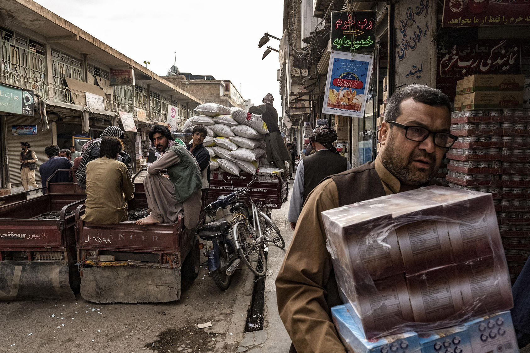 Afghan laborers and merchants moved goods through a bazaar known for Iranian dry foodstuffs and other sundries in Herat, Afghanistan, which is sometimes called “Little Iran,” April 16, 2017. (Bryan Denton/The New York Times)