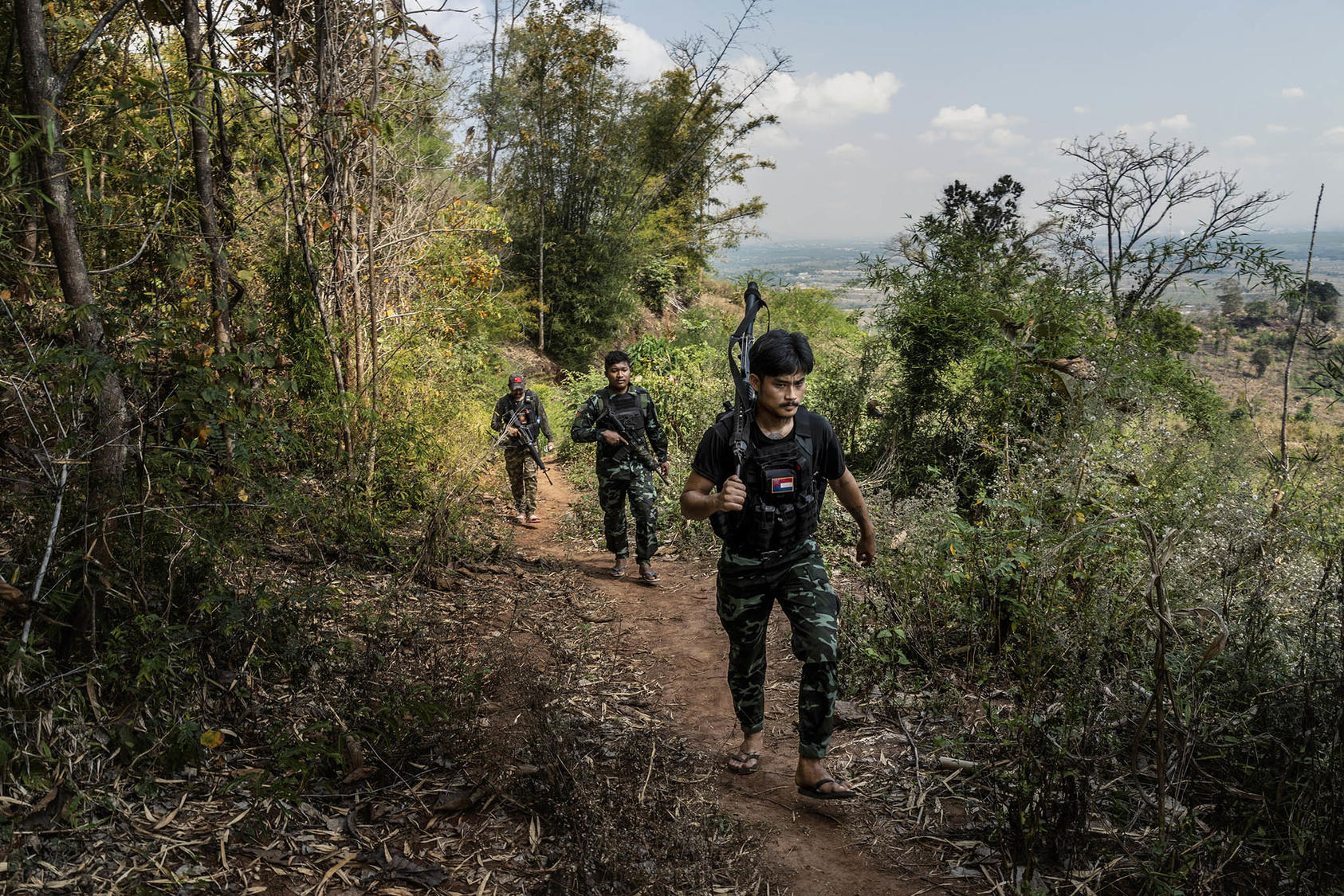 Members of an ethnic rebel group patrol a front-line area near government military positions in the Kayin State of Myanmar. March 9, 2022. (Adam Dean/The New York Times)