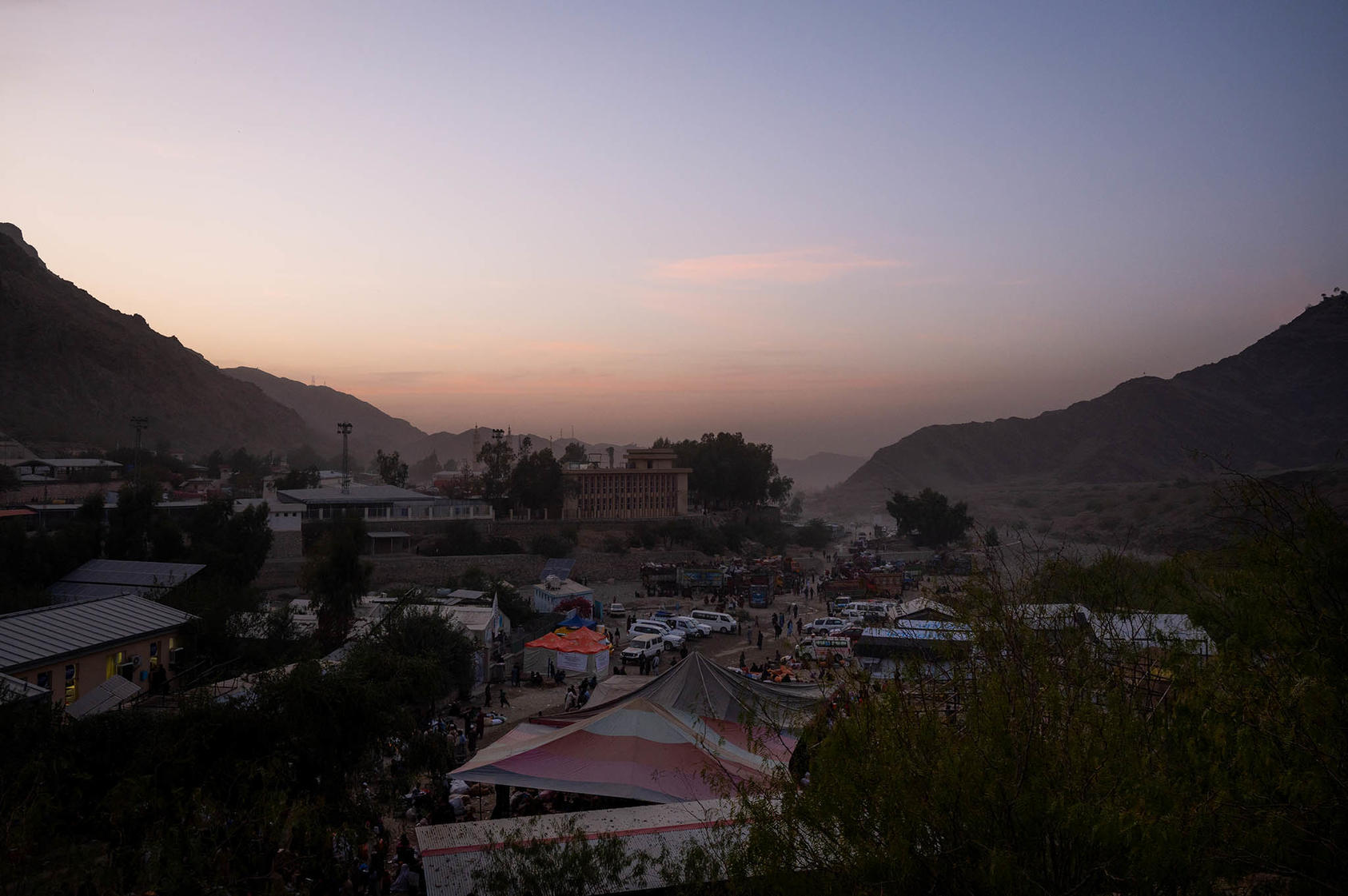 Dusk at the busy Torkham border crossing between eastern Afghanistan and Pakistan. October 23, 2023. (Elise Blanchard/The New York Times)