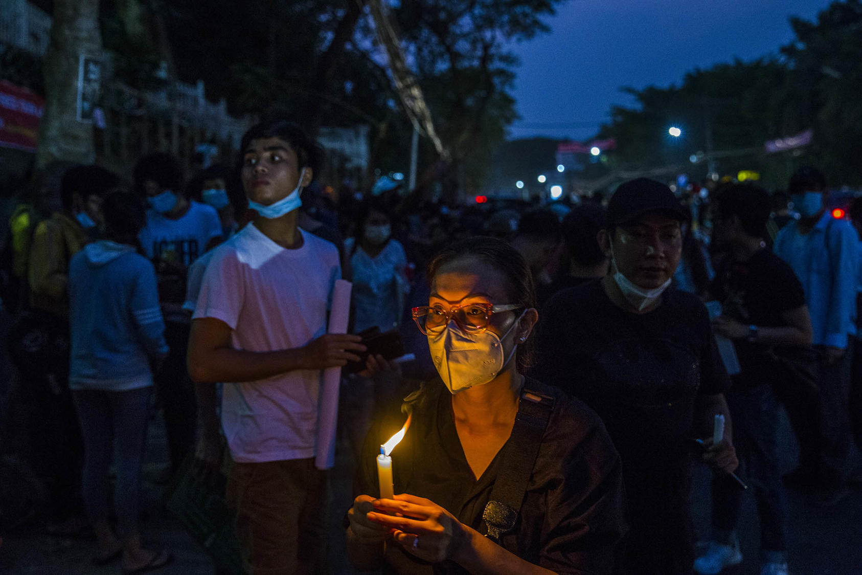 Protestors hold a candlelight vigil for the victims who died in recent government crackdowns while demonstrating against the military coup, at the U.S. embassy in Yangon, Myanmar. February 21, 2021. (The New York Times)