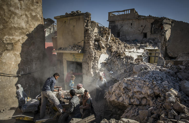 A family works to rebuild a home that was destroyed in the fight to defeat the Islamic State group in the Old City of Mosul, Iraq. (Ivor Prickett/The New York Times)