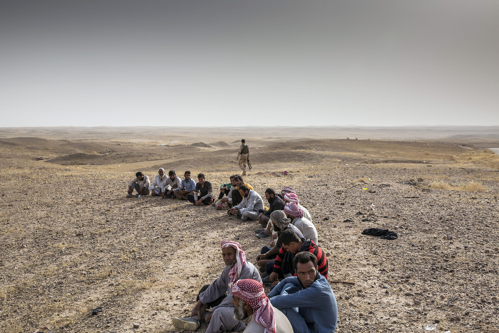 Displaced people wait to be cleared for entry to Kirkuk, Iraq, Oct. 1, 2017. (Ivor Prickett/The New York Times)