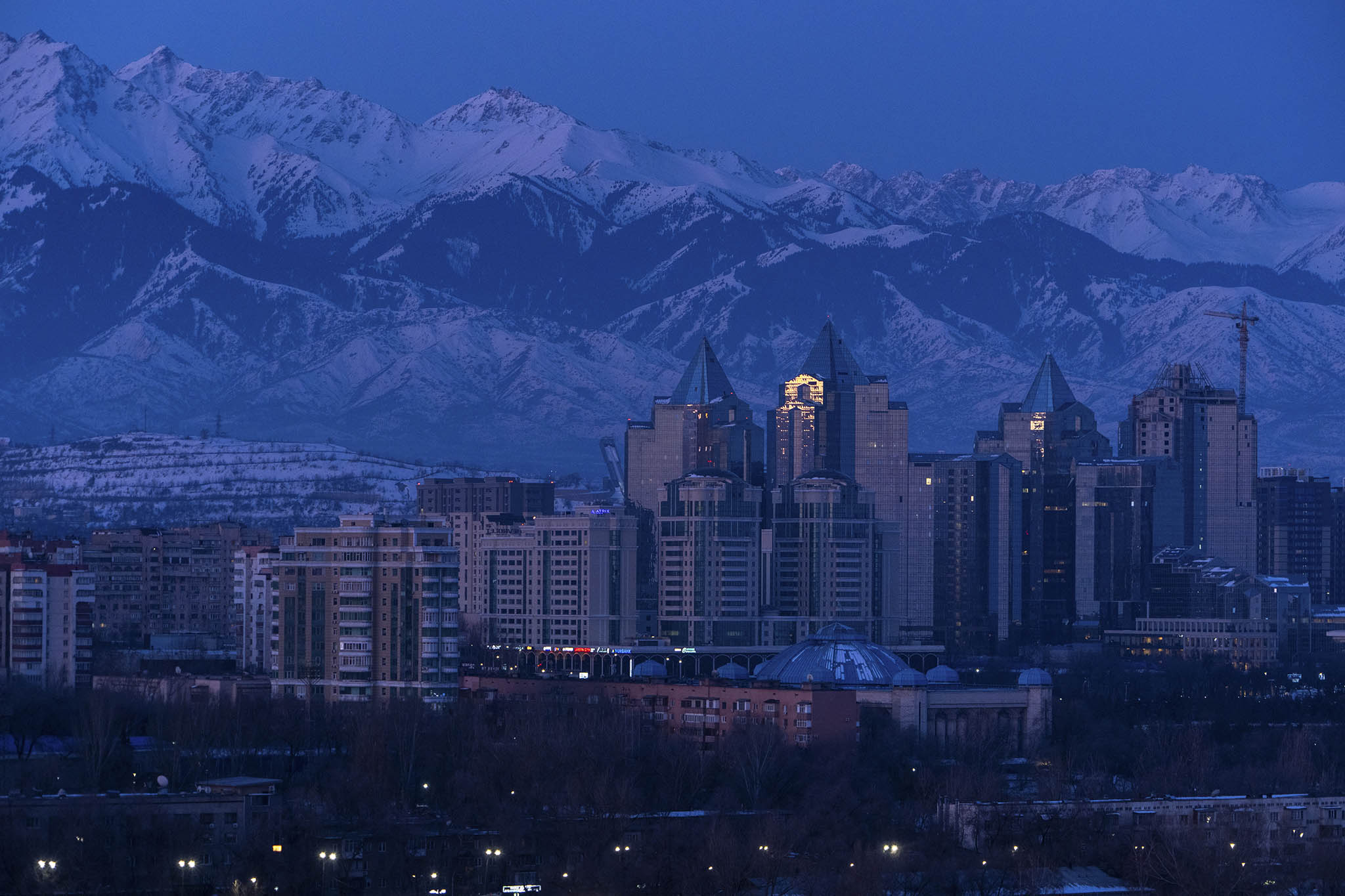 The skyline of Almaty, Kazakhstan's wealthiest city, before sunrise. March 11, 2024. (Chang W. Lee/The New York Times)