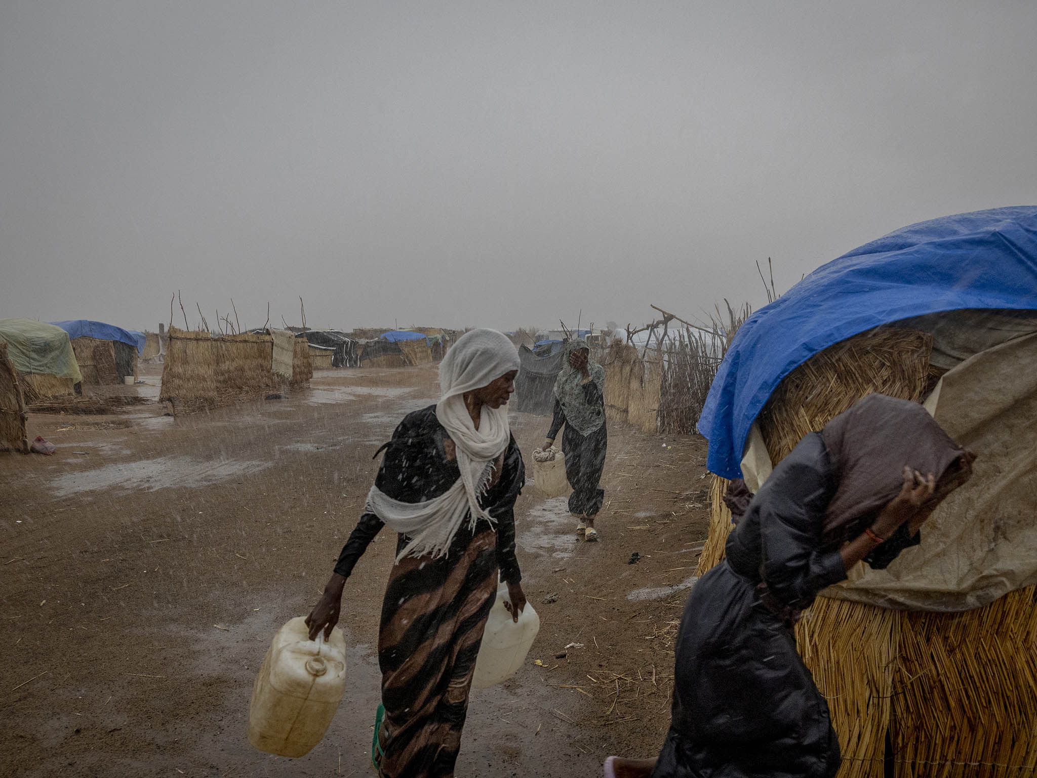 A downpour marks the start of the rainy season in a refugee camp for Sudanese fleeing the civil war in Adre, Chad. July 9, 2024. (Ivor Prickett/The New York Times)