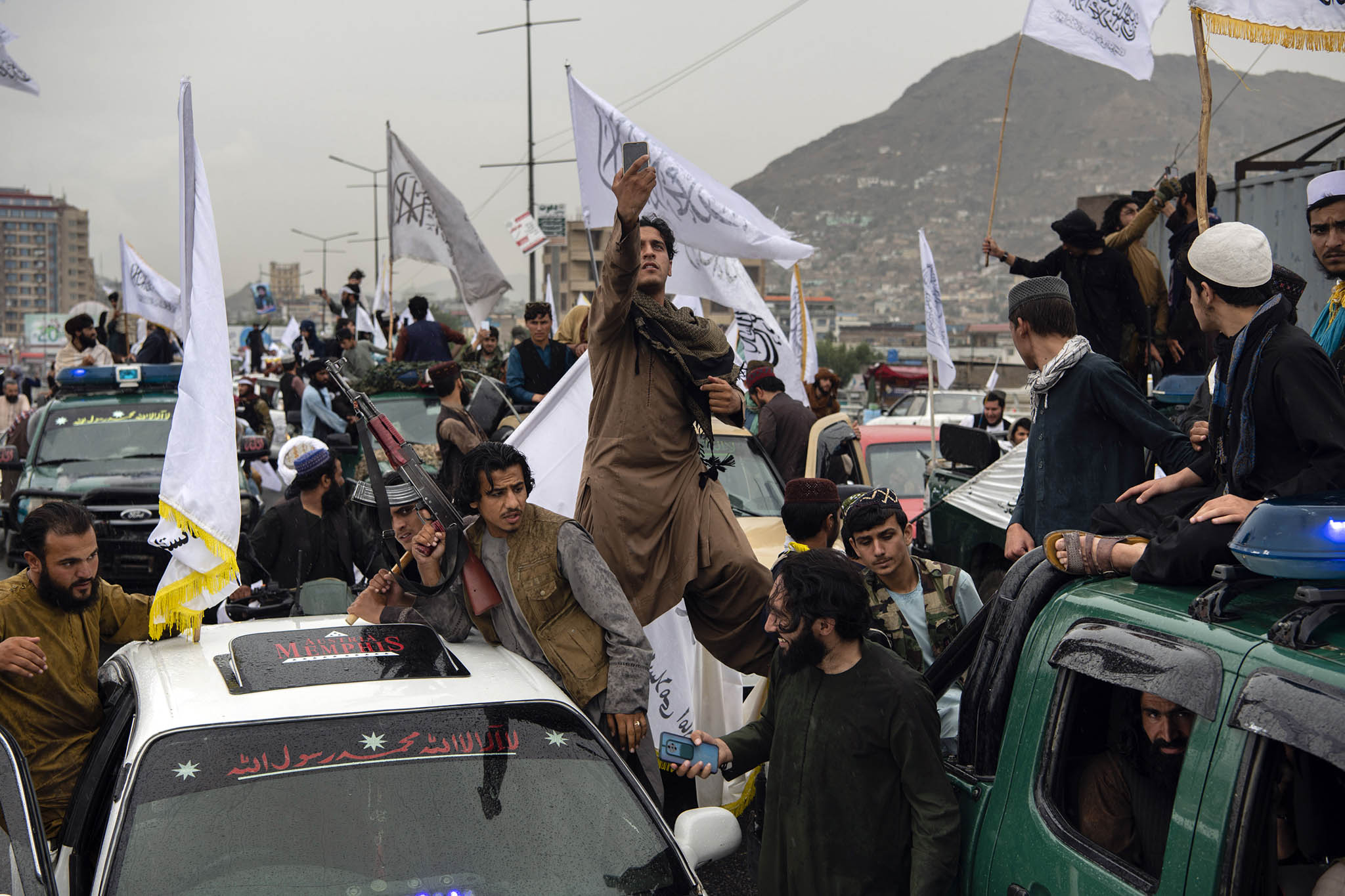 Taliban fighters, many of whom drove in from neighboring provinces, gather in Kabul to celebrate the first anniversary of their seizure of control over the capital on Monday, Aug. 15, 2022. (Kiana Hayeri/The New York Times)