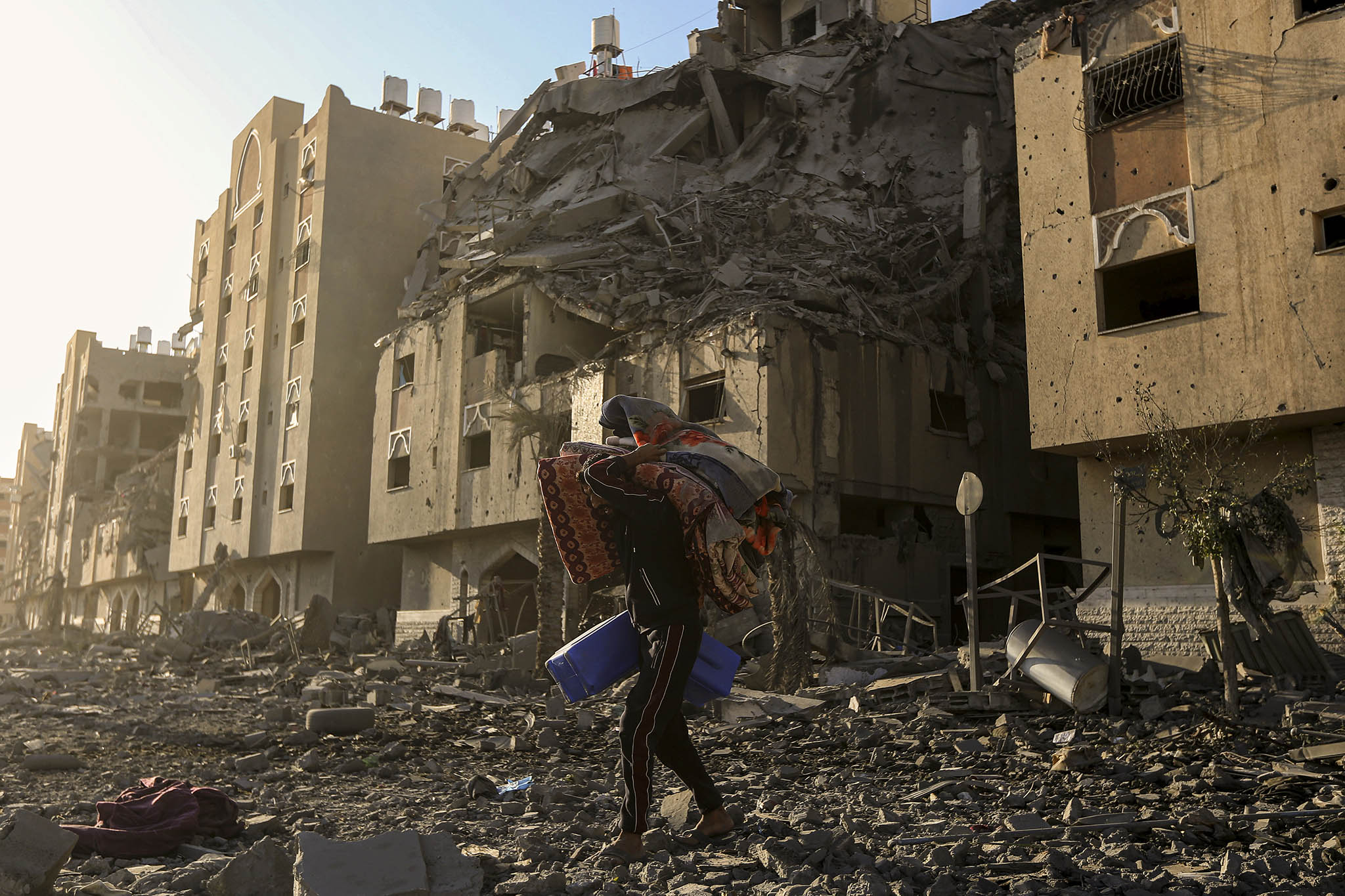 A resident of Khan Younis salvages belongings following an Israeli airstrike, in the southern Gaza Strip on Dec. 2, 2023. (Yousef Masoud/The New York Times)