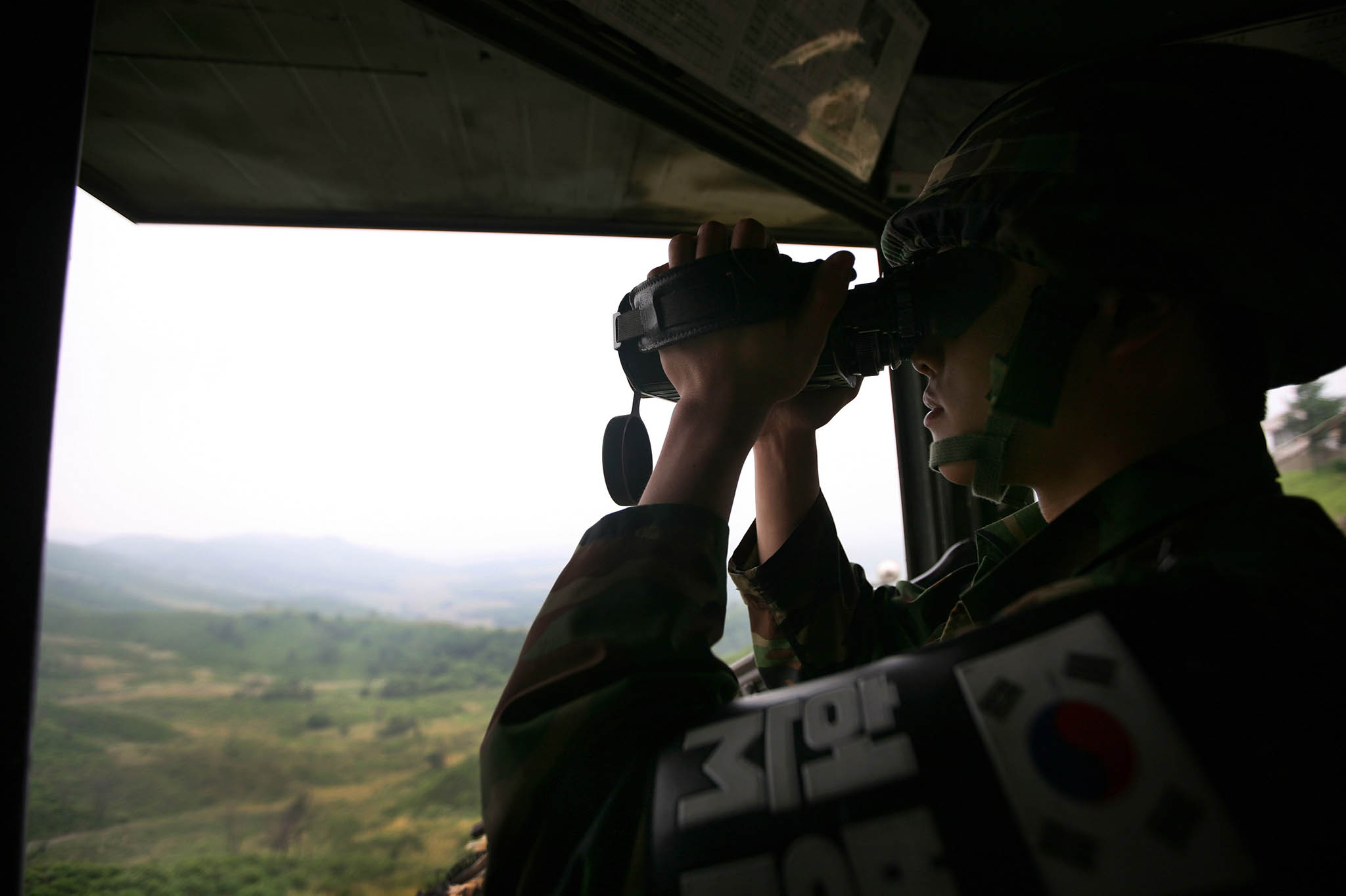 A soldier keeps watch at the Demilitarized Zone from Yeoncheon, South Korea. June 2, 2009. (Woohae Cho/The New York Times)