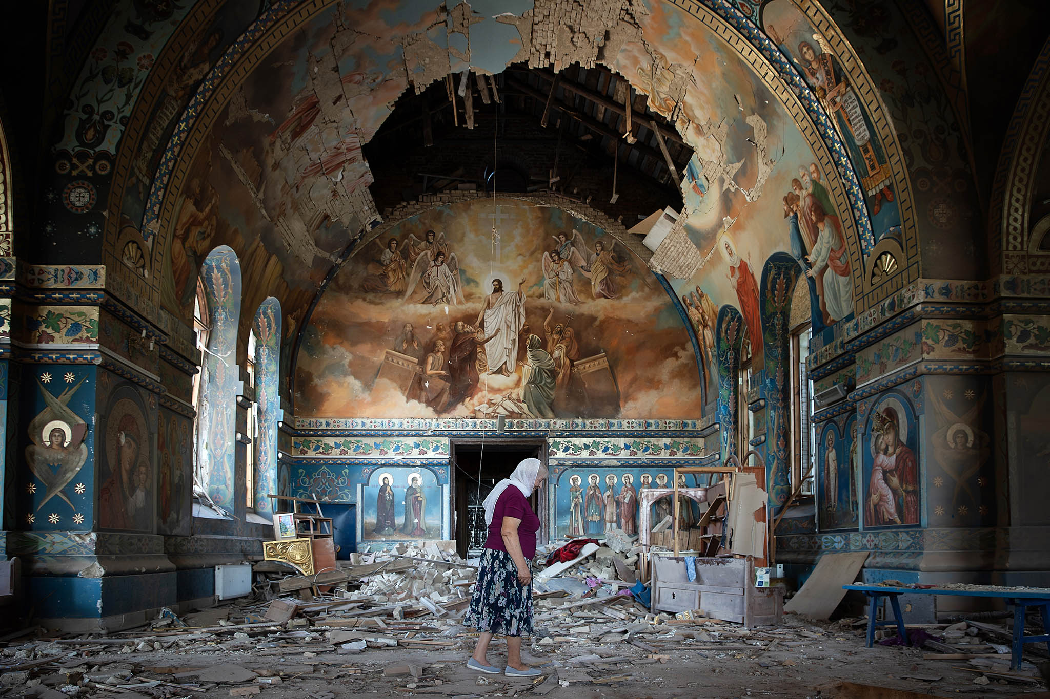 Lyudmilla Petrovna in the church where she sells candles and religious icons, which was damaged by Russian shelling, in Novoekonomiche, about 45 miles west of Toretsk, Ukraine, on Aug. 1, 2024. (Tyler Hicks/The New York Times)