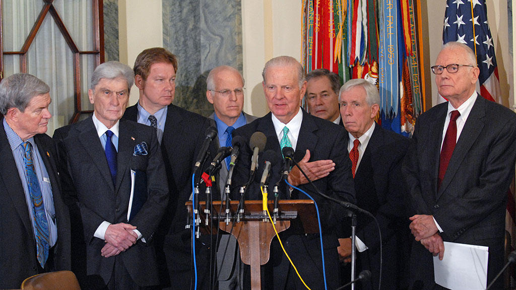 Iraq study group co-chair James Baker discusses the new initiative as fellow co-chair Lee Hamilton (far right) and others look on.