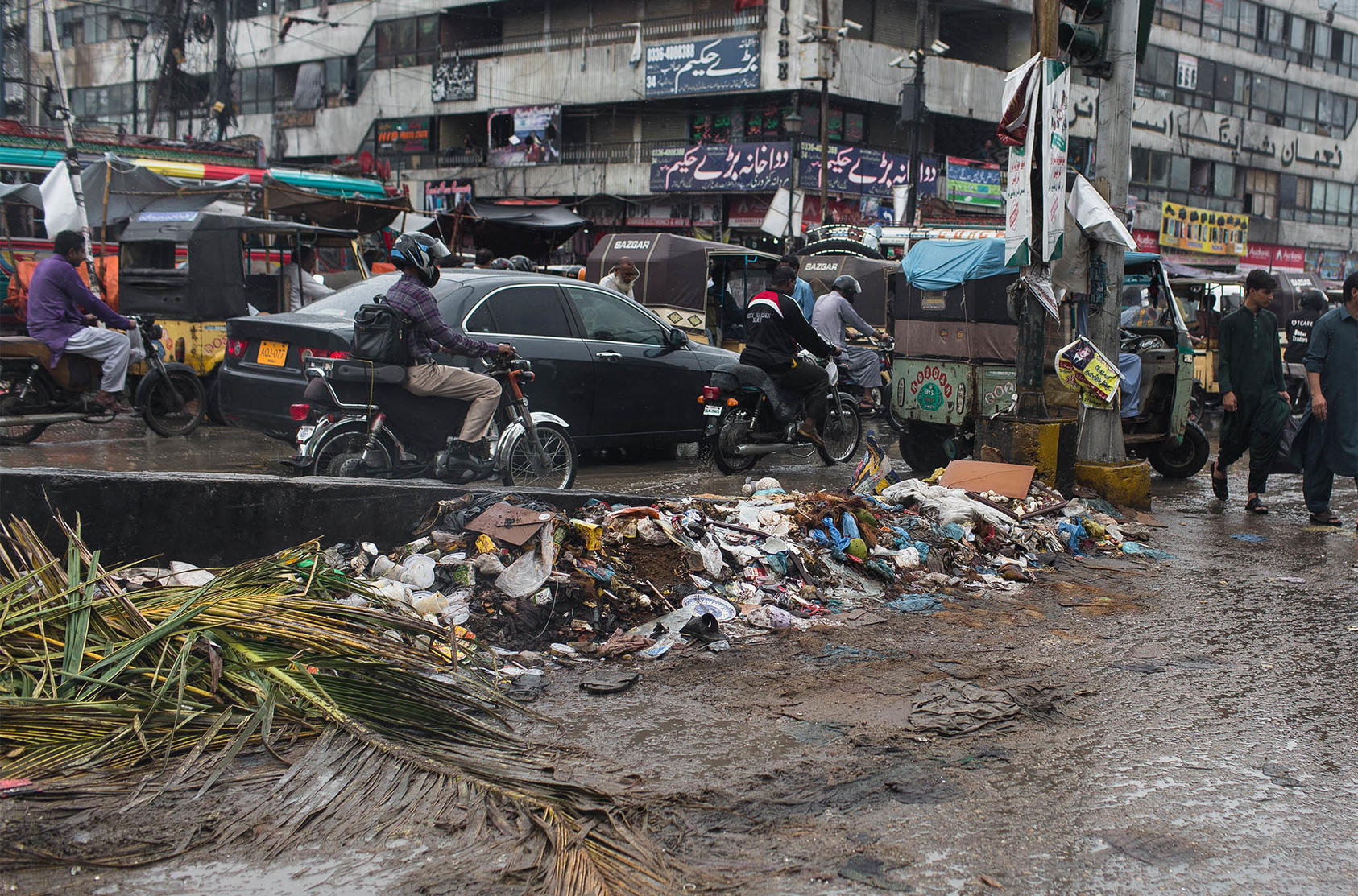 A mound of trash along a street in Karachi, Pakistan after heavy rainfall. Aug. 28, 2019. (Mustafa Hussain/The New York Times)
