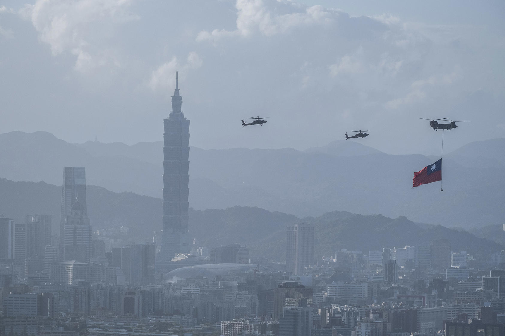 Taiwanese helicopters fly the country’s flag through the capital Taipei. October 5, 2021. (Lam Yik Fei/The New York Times)