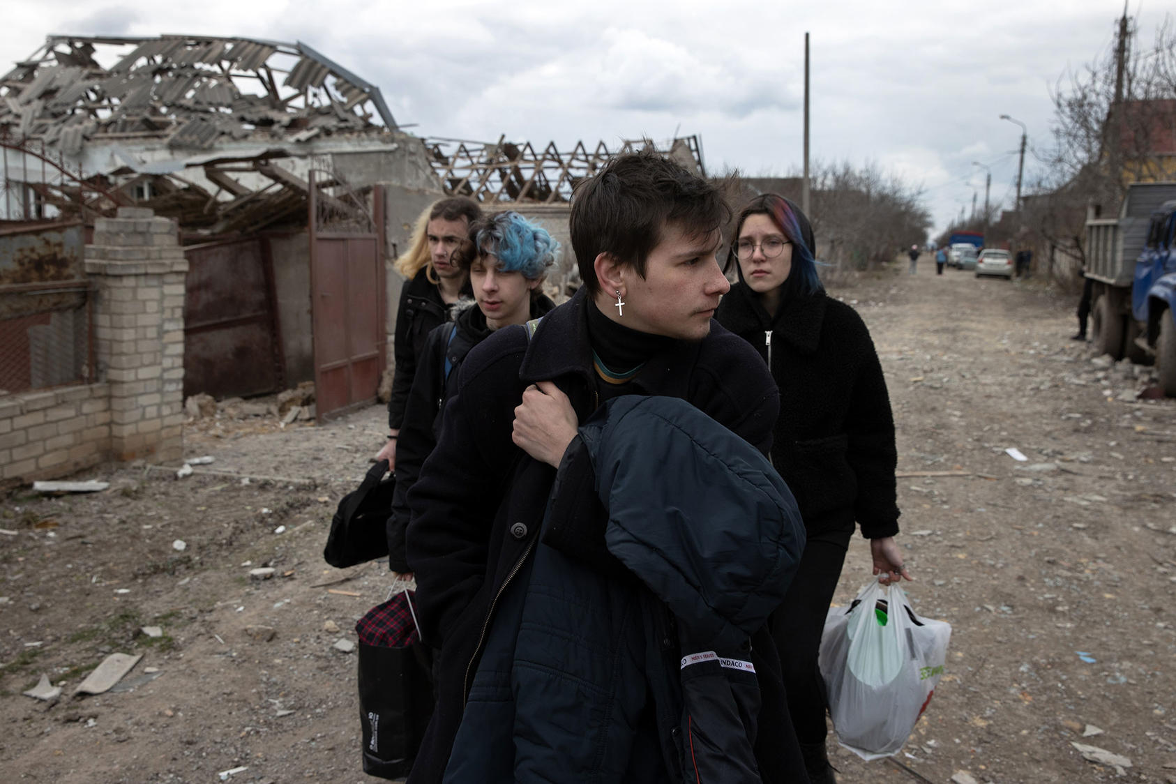 Ukrainians leave home in the village of Ternovka, southern Ukraine, March 8 after it was struck by Russian forces. War crimes investigators are gathering details on the pattern of Russian attacks on civilian targets. (Tyler Hicks/The New York Times)