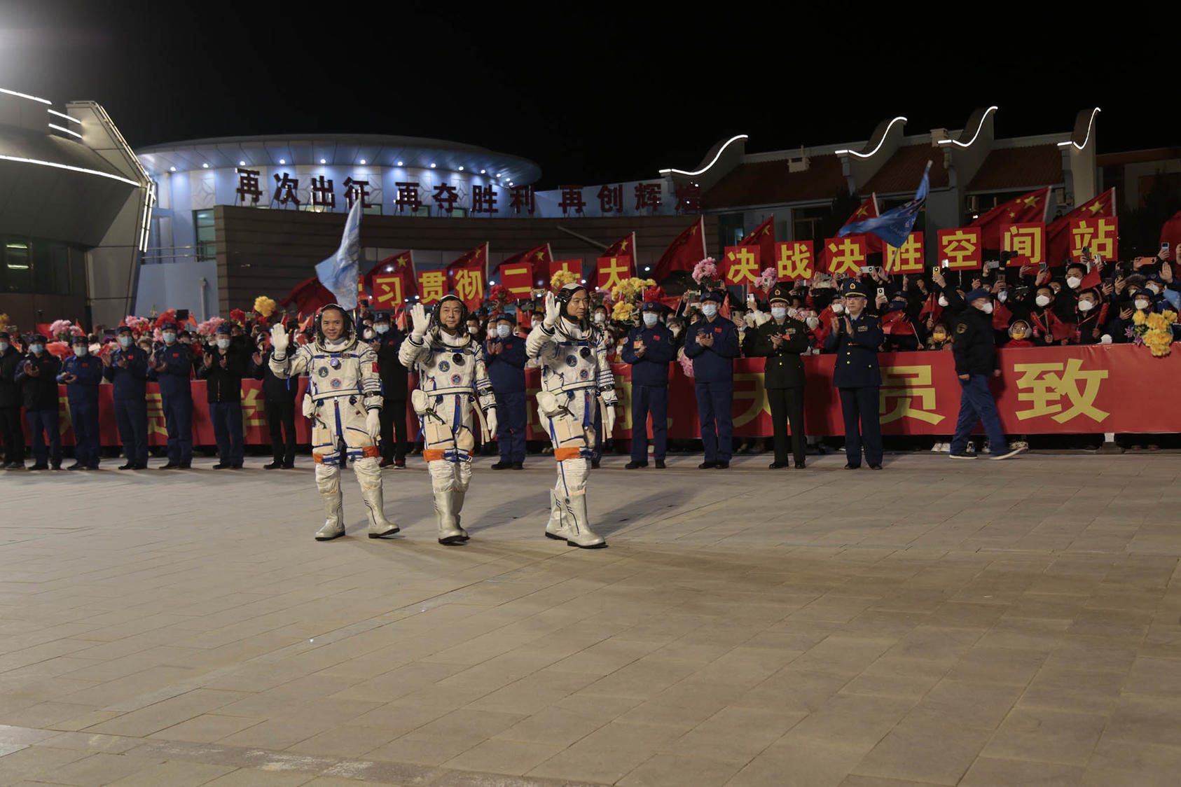Chinese astronauts wave to a crowd before boarding the Shenzhou 15 spacecraft at Jiuquan Satellite Launch Center on their way to the country’s Tiangong space station, Nov. 29, 2022. (You Li/The New York Times)