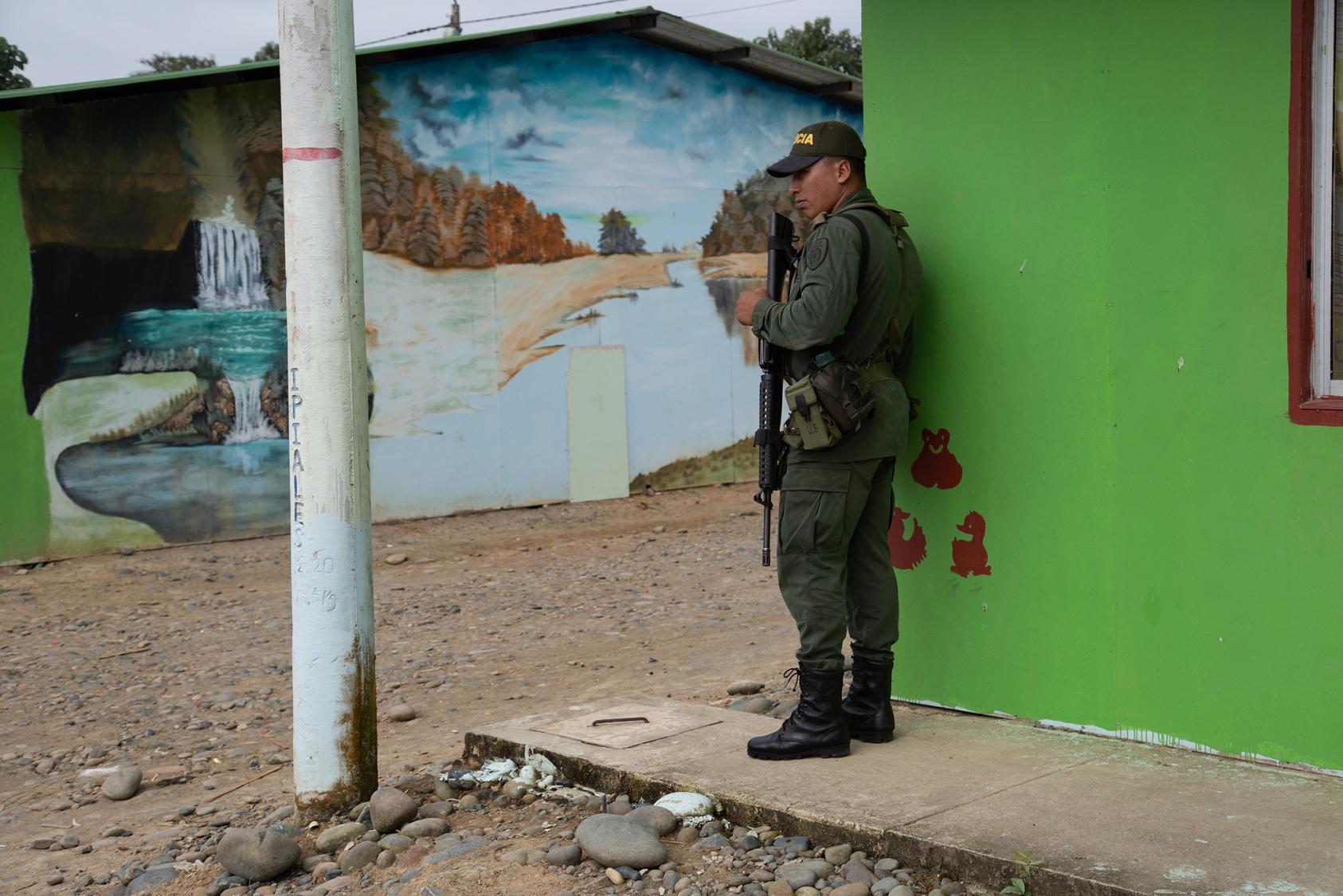 A police officer stands guard at the socio-economic reintegration zone in La Variante for former FARC members and their families. Tumaco, Nariño, Colombia. September 19, 2019 (Photo: USIP)