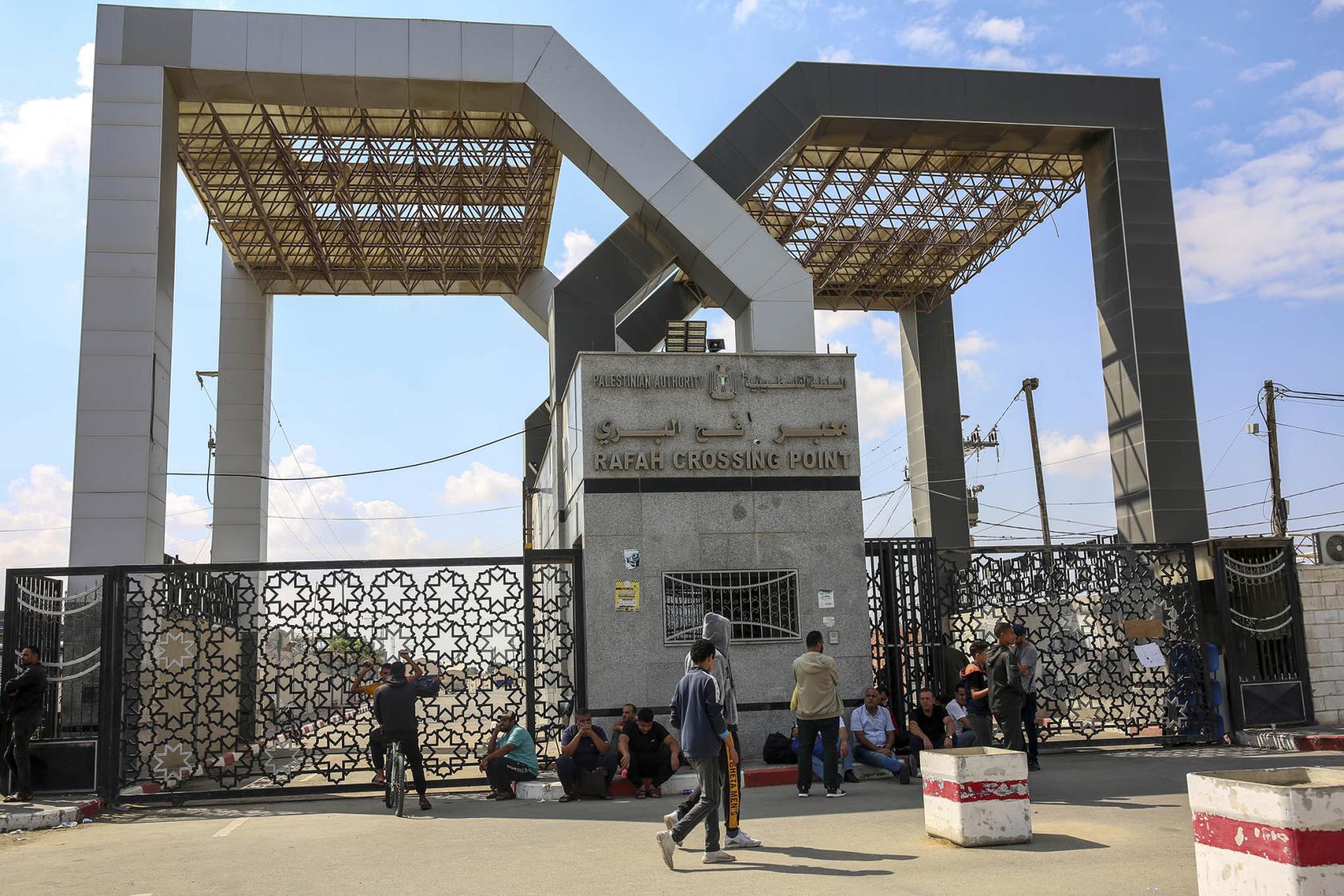 People gather on the Gaza side of the closed Rafah border crossing with Egypt on Monday, Oct. 16, 2023. (Samar Abu Elouf/The New York Times)