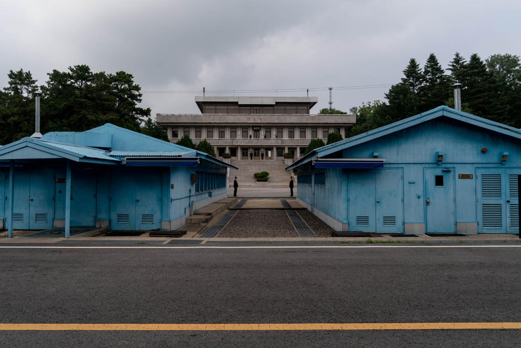 The blue meeting huts along the demarcation line in the truce village of Panmunjom in the Demilitarized Zone between North Korea and South Korea. June 30, 2019. (Erin Schaff/The New York Times)