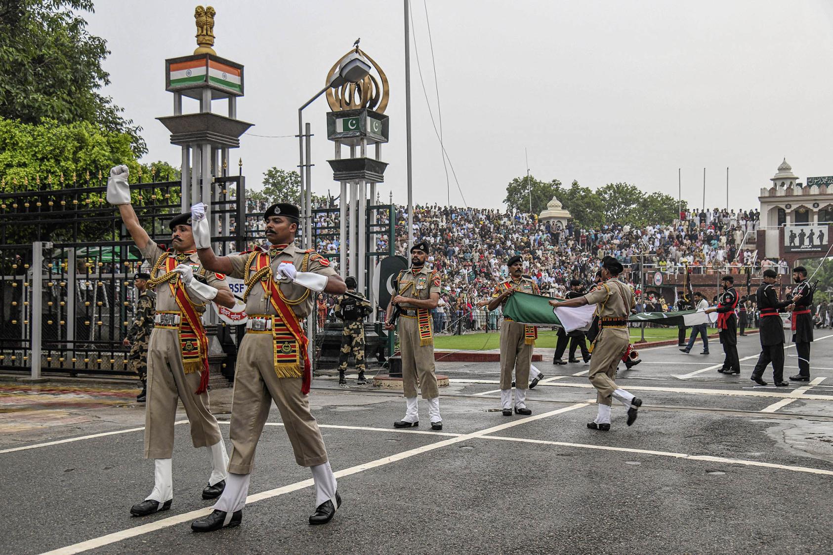 A security force on the Indian side of the Attari-Wagah border post, with Pakistani forces in the background, near Amritsar, India, Aug. 7, 2022. (Atul Loke/The New York Times)