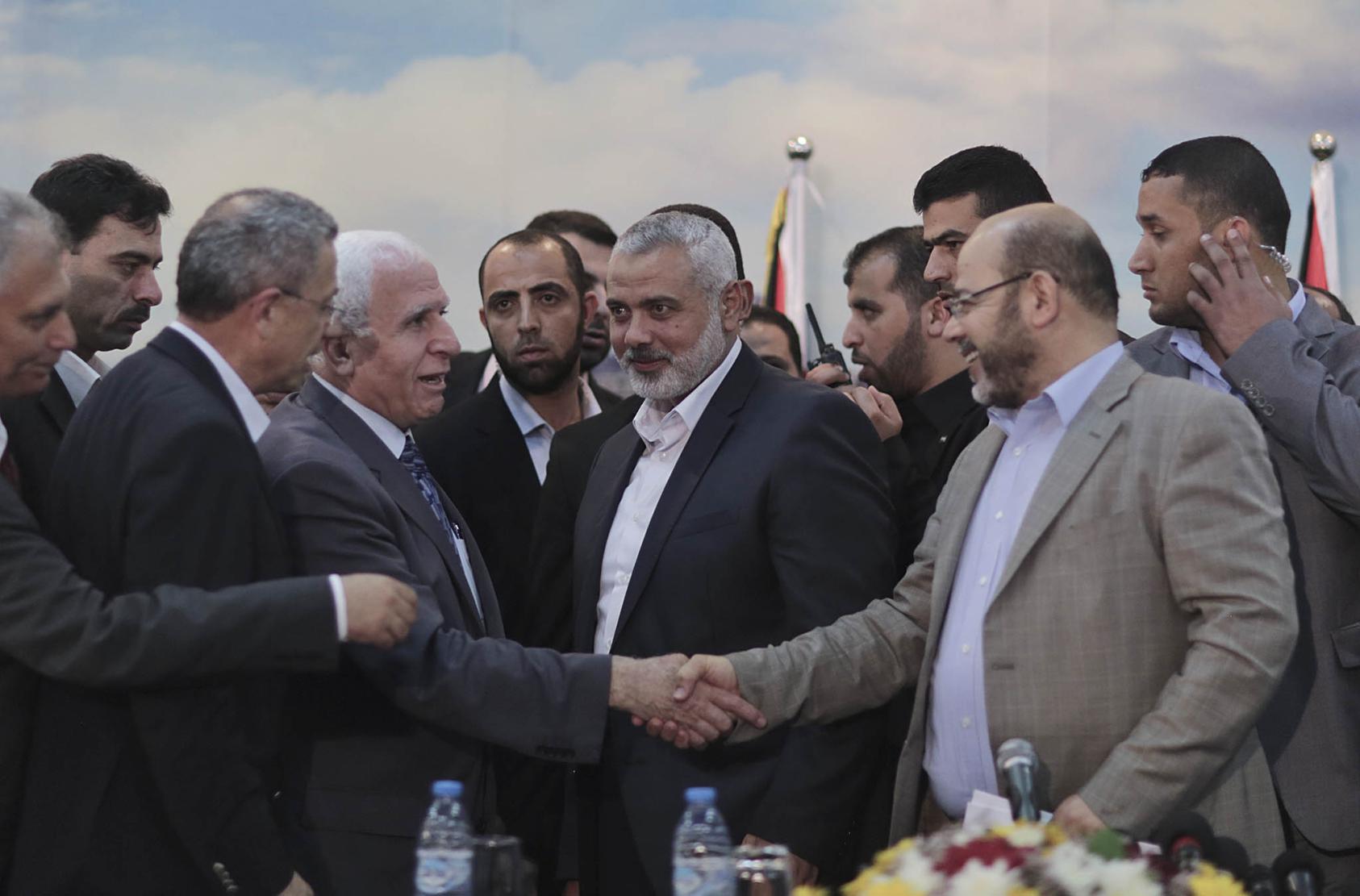 Senior Hamas and Fatah officials after they announced an agreement to heal what then had been a seven-year schism and form a unity government, in Gaza City, April 23, 2014. (Wissam Nassar/The New York Times)