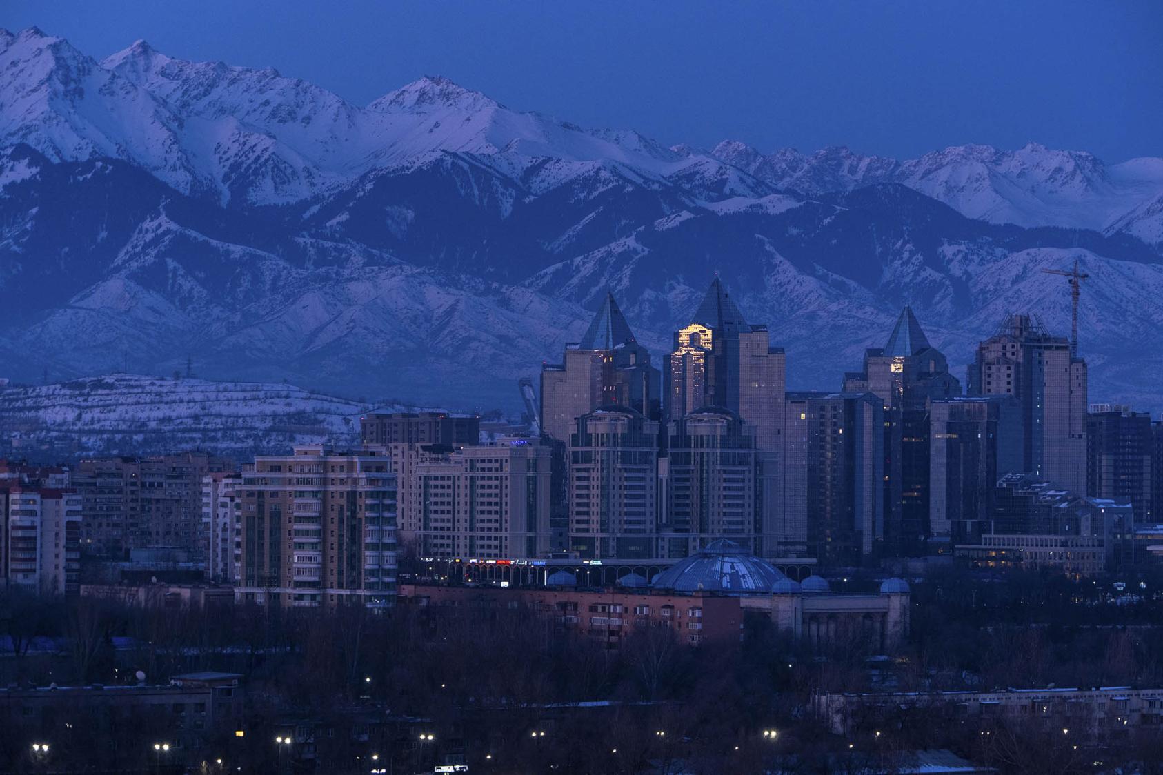 The skyline of Almaty, Kazakhstan's wealthiest city, before sunrise. March 11, 2024. (Chang W. Lee/The New York Times)