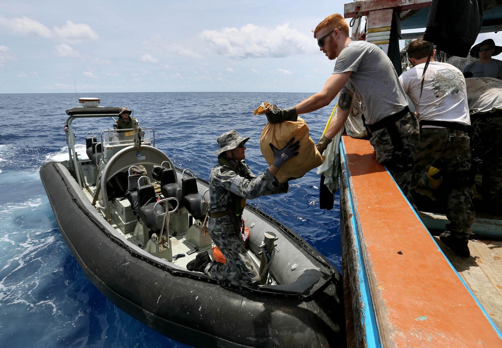 Australian Navy forces transport packages of heroine following a successful drug seizure in the Indian Ocean. (Australian Navy)