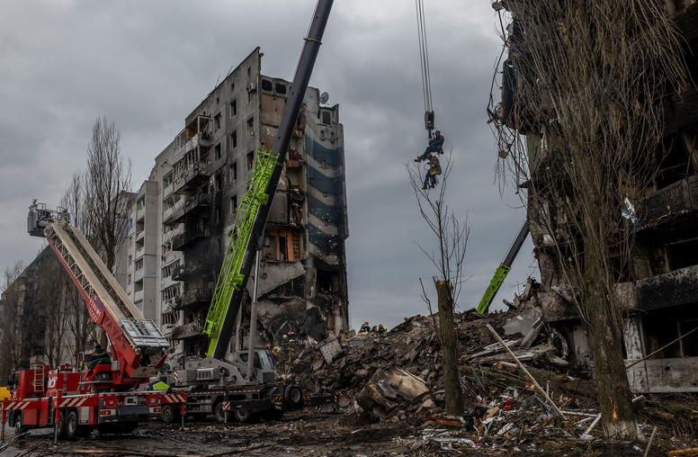 Rescue personnel use a crane to view inside the ruins of a bombed apartment building in Borodyanka, a town about 20 miles northwest of Kyiv, Ukraine on Saturday April 9, 2022. (Daniel Berehulak/The New York Times)