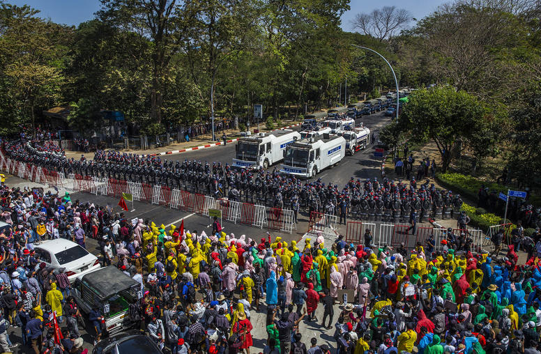 Protesters and security forces facing off in Yangon, Myanmar. February 9, 2021. (The New York Times)