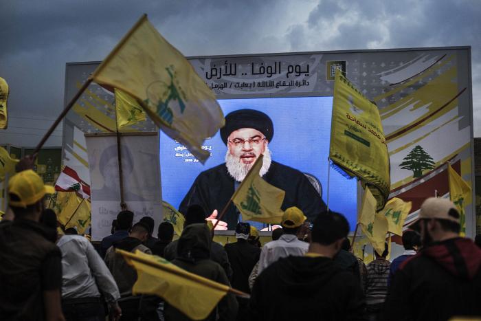 Sayyed Hassan Nasrallah, the leader of Hezbollah, addresses people from a screen in Baalbek, Lebanon, on May 1, 2018. (Diego Ibarra Sanchez/The New York Times)
