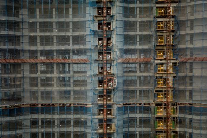 Construction workers on a new Chinese casino, condo and hotel development on the seafront in Sihanoukville, Cambodia, Feb. 17, 2018. (Adam Dean/The New York Times)